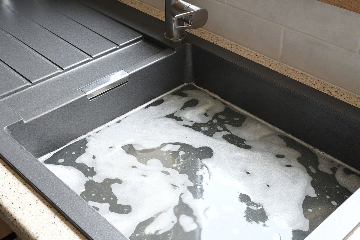 A sink drain being cleared during professional drain cleaning